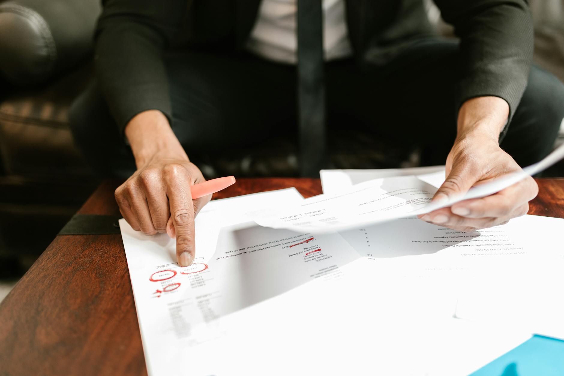 close up photo of person pointing on documents